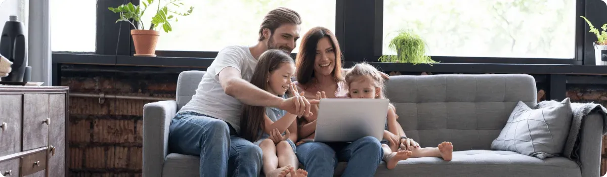 Family relaxing together on a sofa at home