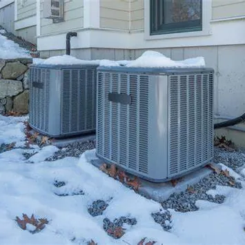 Outdoor heat pump units beside a house in winter