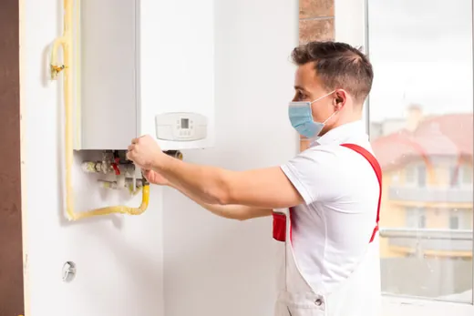 Technician adjusting a tankless water heater