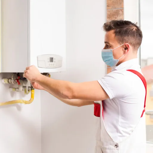 Technician adjusting a tankless water heater