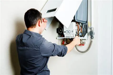 Technician servicing a wall-mounted boiler
